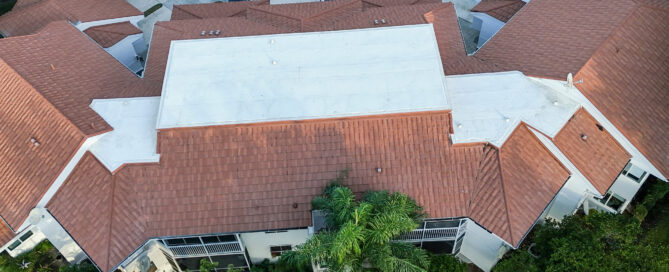 Commercial roofing contractor evaluating a Palm Beach County business roof following a roof leak and weather-related damage.