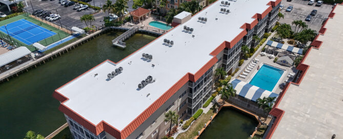 Licensed commercial roofing contractors installing a white TPO roof membrane in Fort Lauderdale by Rainbow Roofing Solutions, LLC