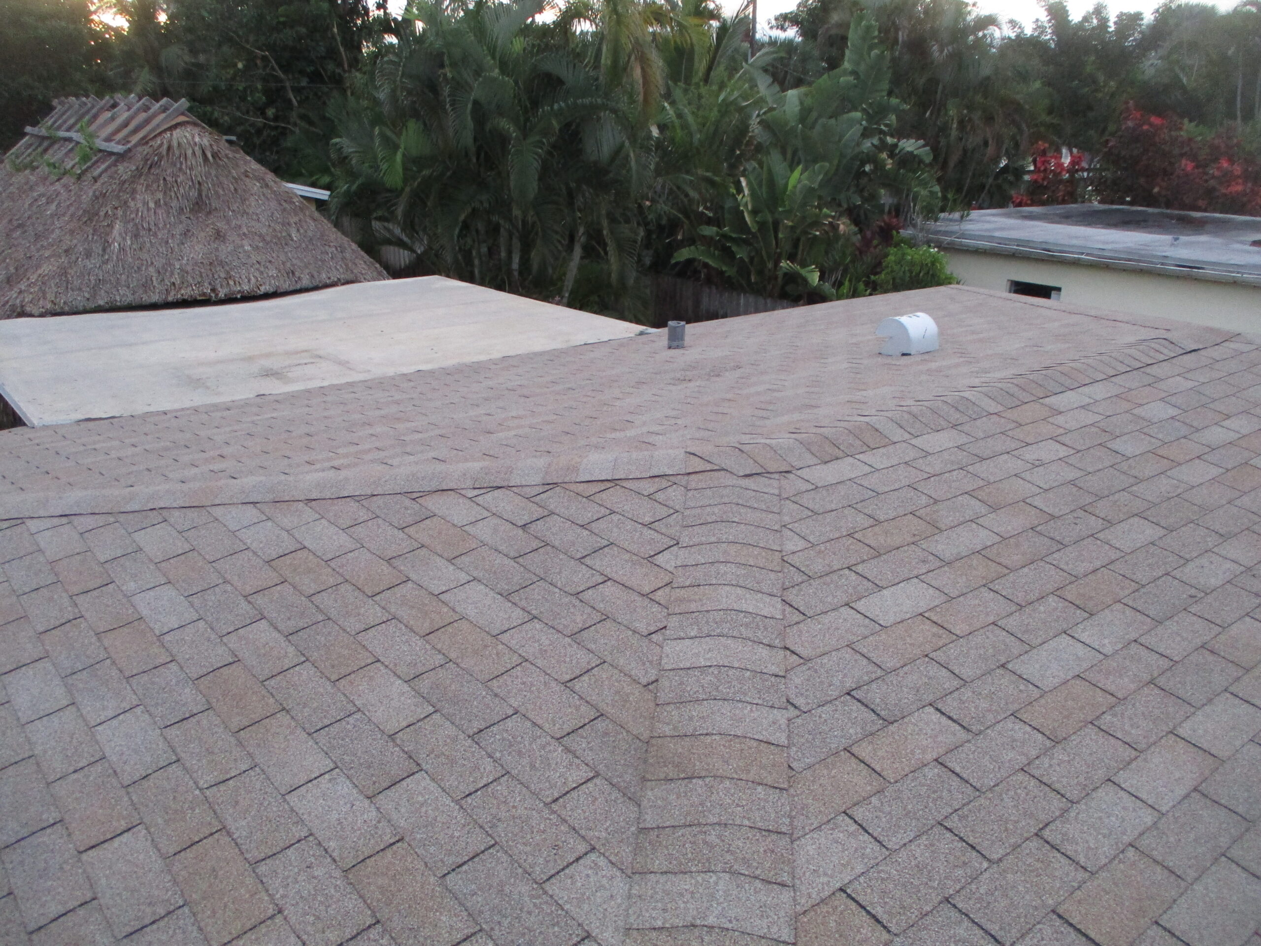 Roofing professional performing a residential roof inspection for a free repair estimate in Fort Lauderdale, Florida