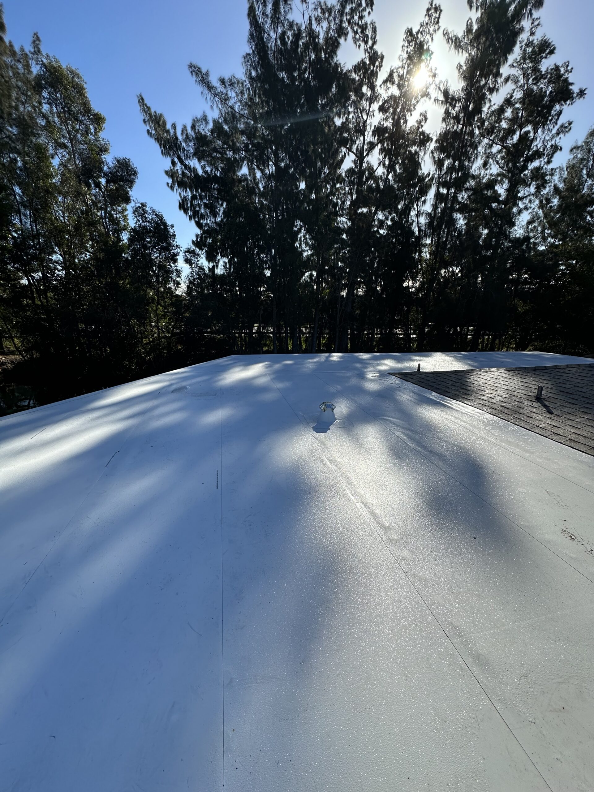 Roofing specialist inspecting a residential roof in Plantation, Florida for leak repair and partial repairs