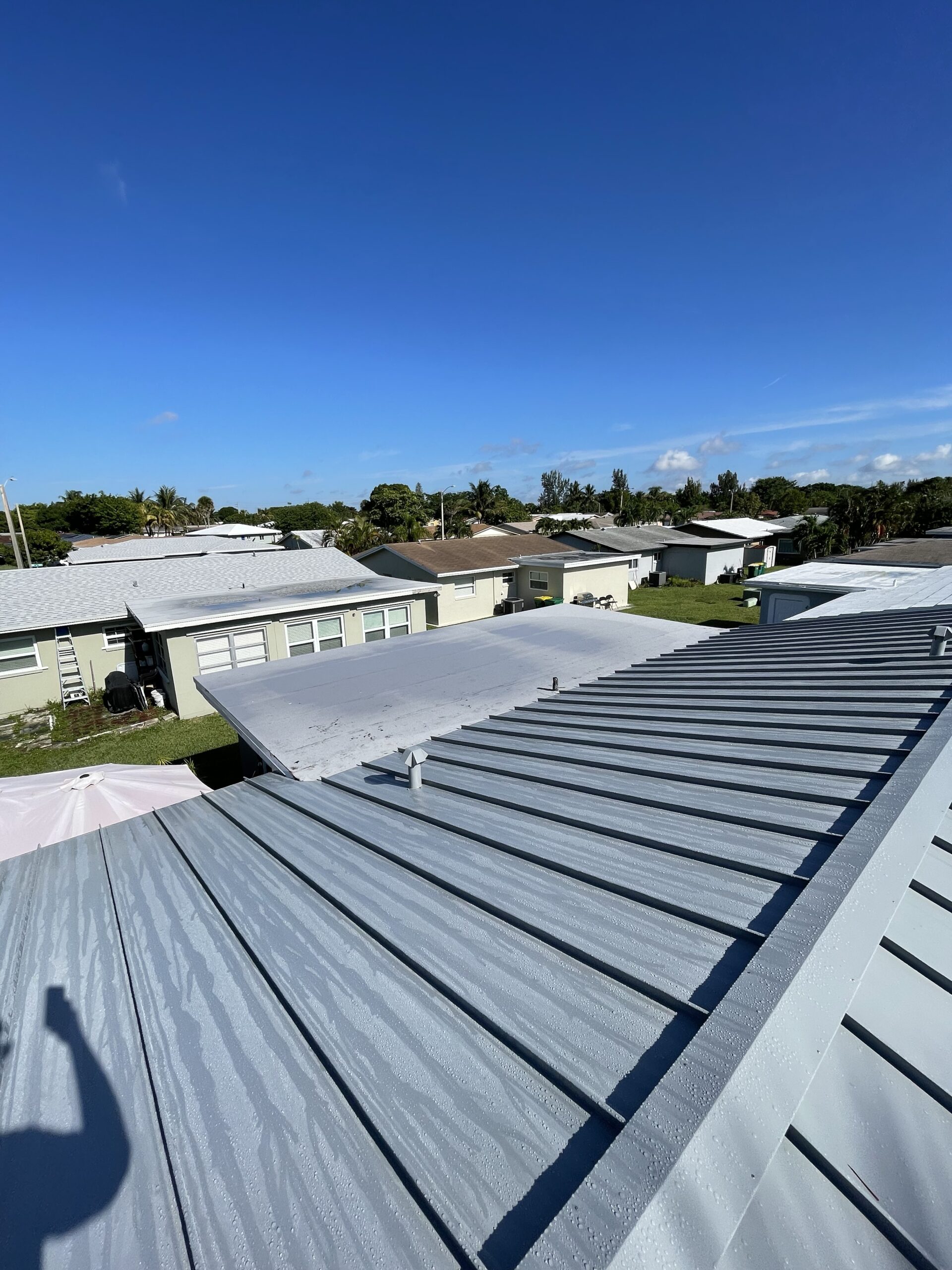 Rainbow Roofing Solutions, LLC team installing commercial metal roof in Fort Lauderdale.