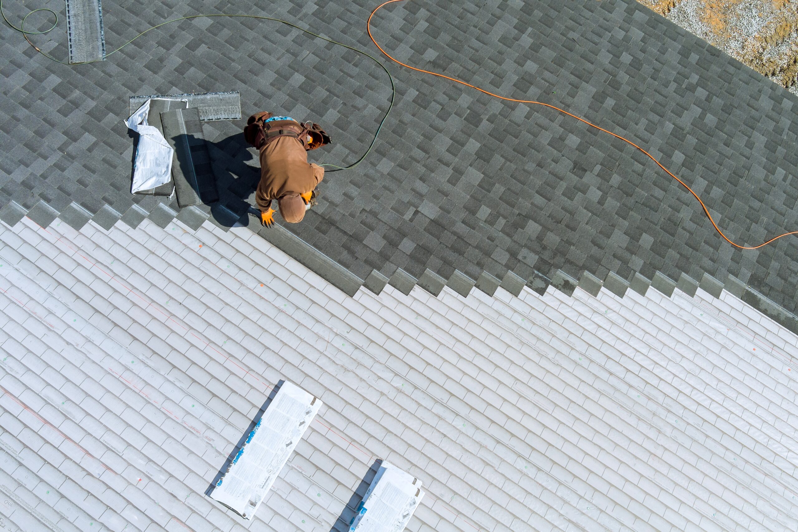 Worker on roof for Commercial Roof Replacement Pompano Beach and Commercial Roof Repairs Pompano Beach